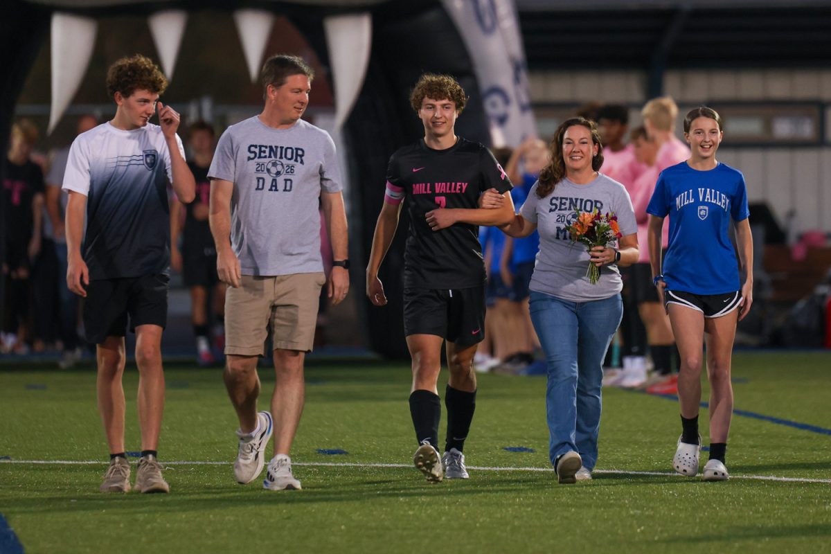 Senior Landon Vincent and his family walk down the field during the senior walk on Thursday Oct. 16.