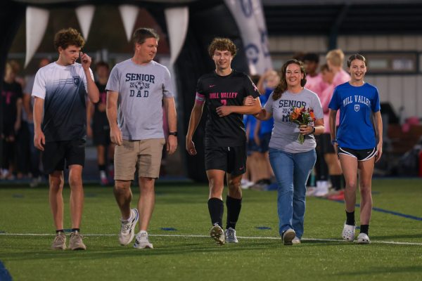 Senior Landon Vincent and his family walk down the field during the senior walk on Thursday Oct. 16.