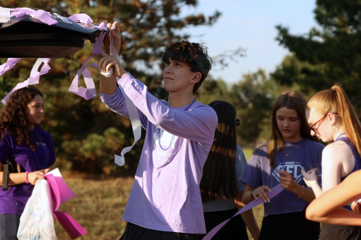 Sophomore Zach Wieland decorates the Relay for Life float with streamers. 