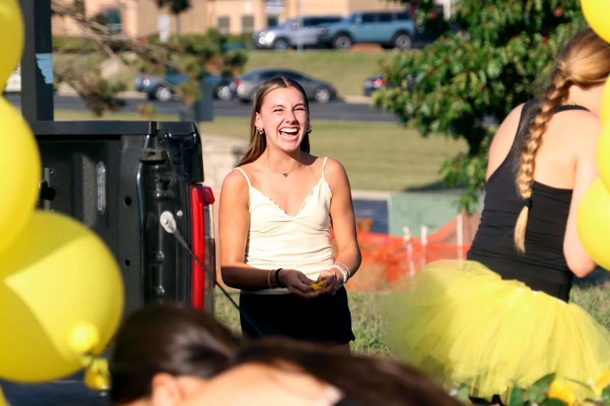 Freshman laugh as they decorate their float in preparation for the parade. 