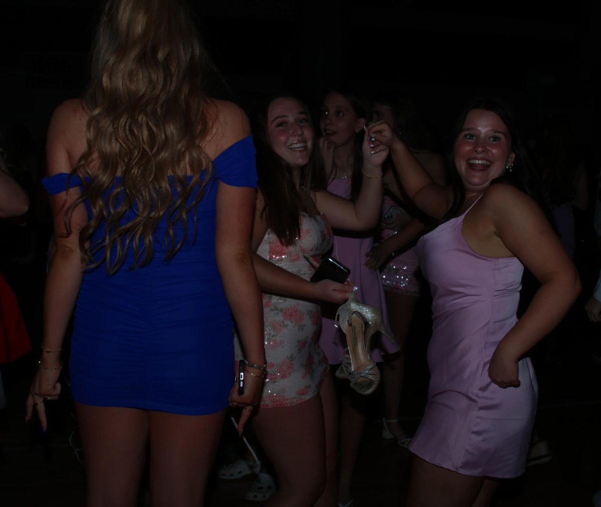 Dancing to the music, seniors Stella Harryman and Bianca Pepe hold hands in the air.