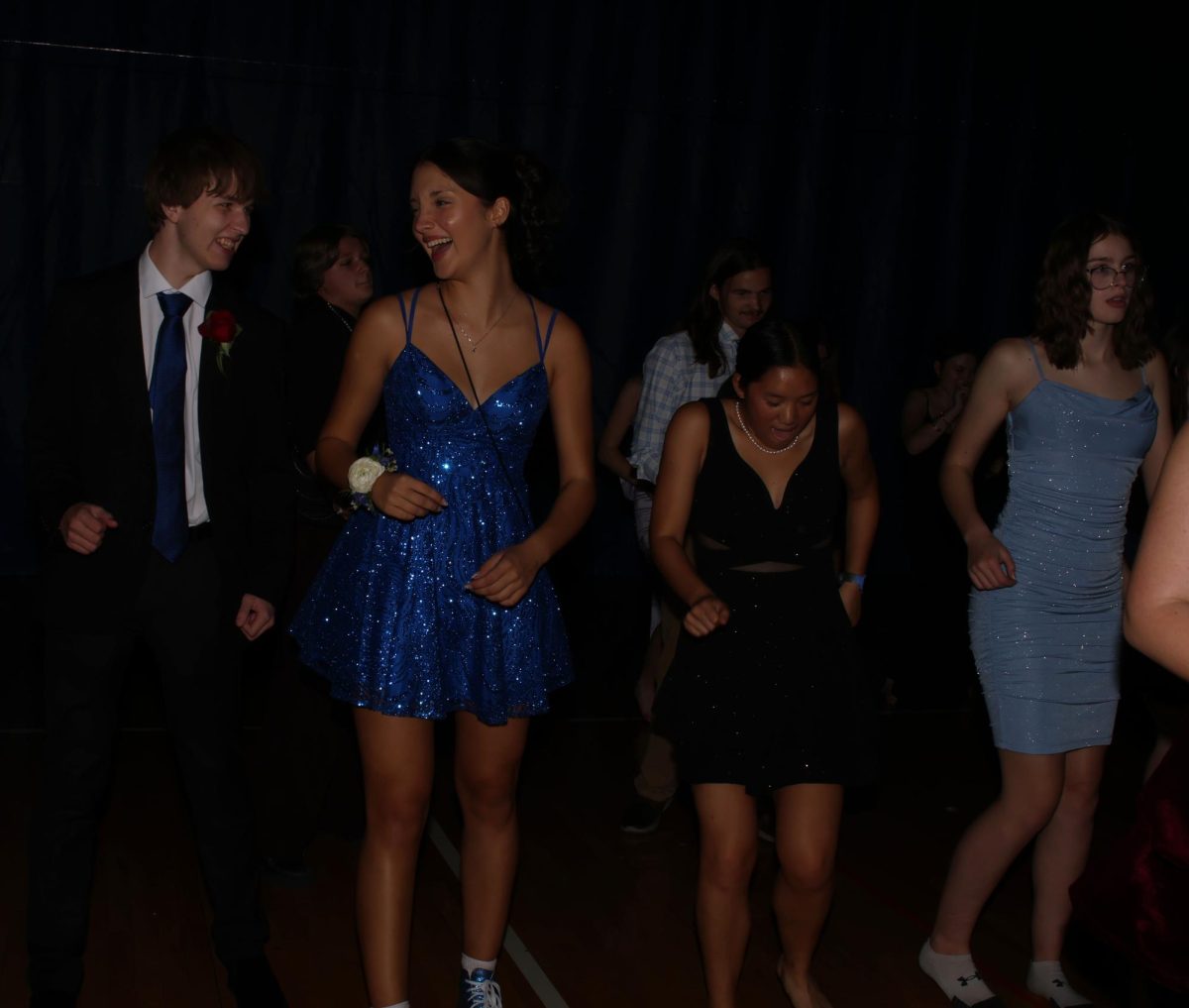 Laughing together, sophomores Landon Pippit and Lily Stewart line dance.
