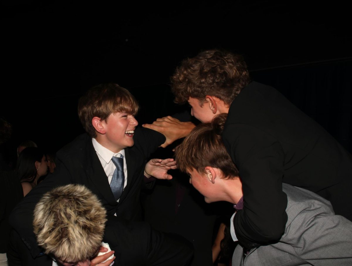 Sharing a laugh, sophomores Miles McGarry and Chase Evans hop on to their friends' backs.