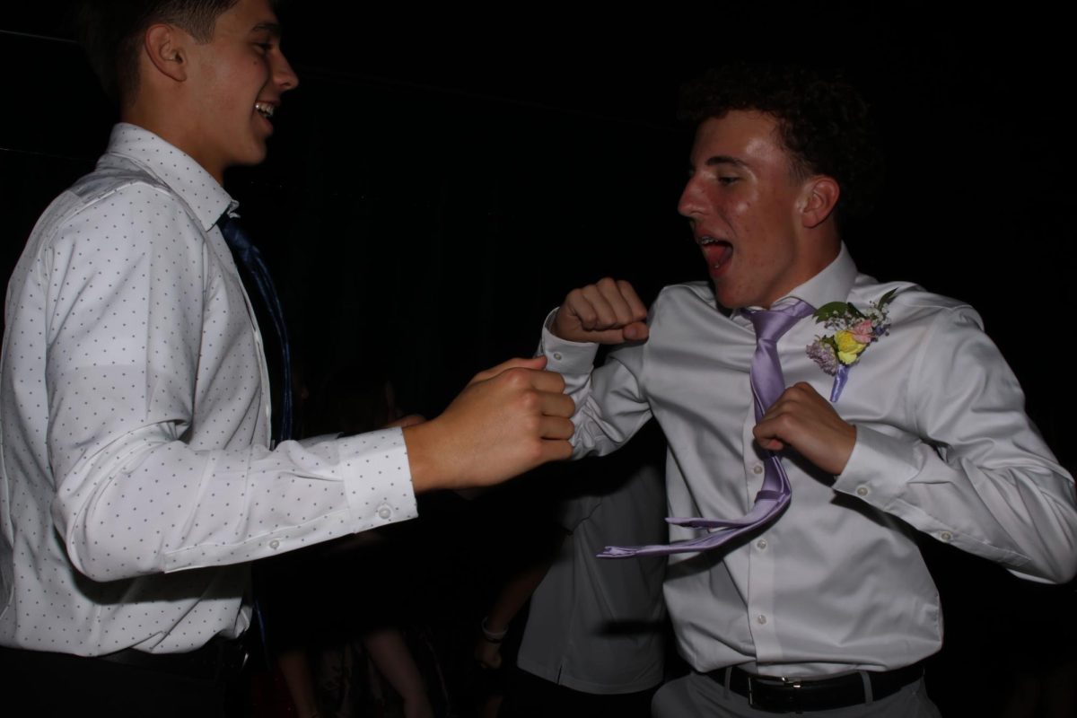 Pumping each other up, sophomores Cooper Fanshier and Kaleb Davis dance together.