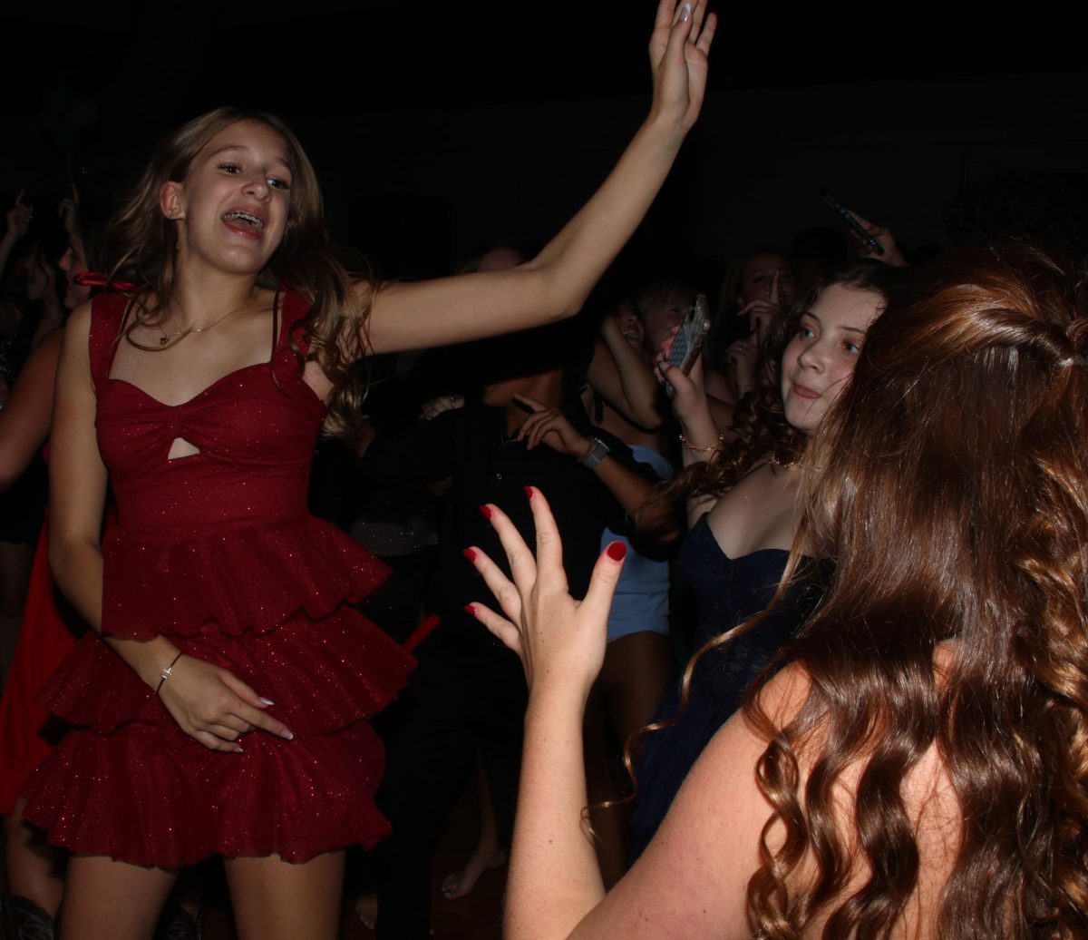 Jumping in the air, freshman Addi Alexander dances to the music.