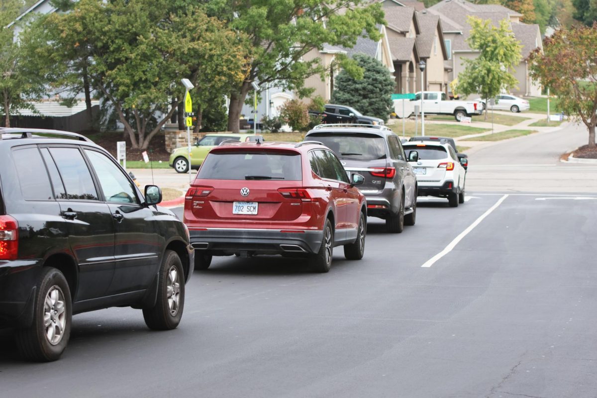 Car lines pile up due to drivers only being able to exist left out of the activity entrance because of the road closure