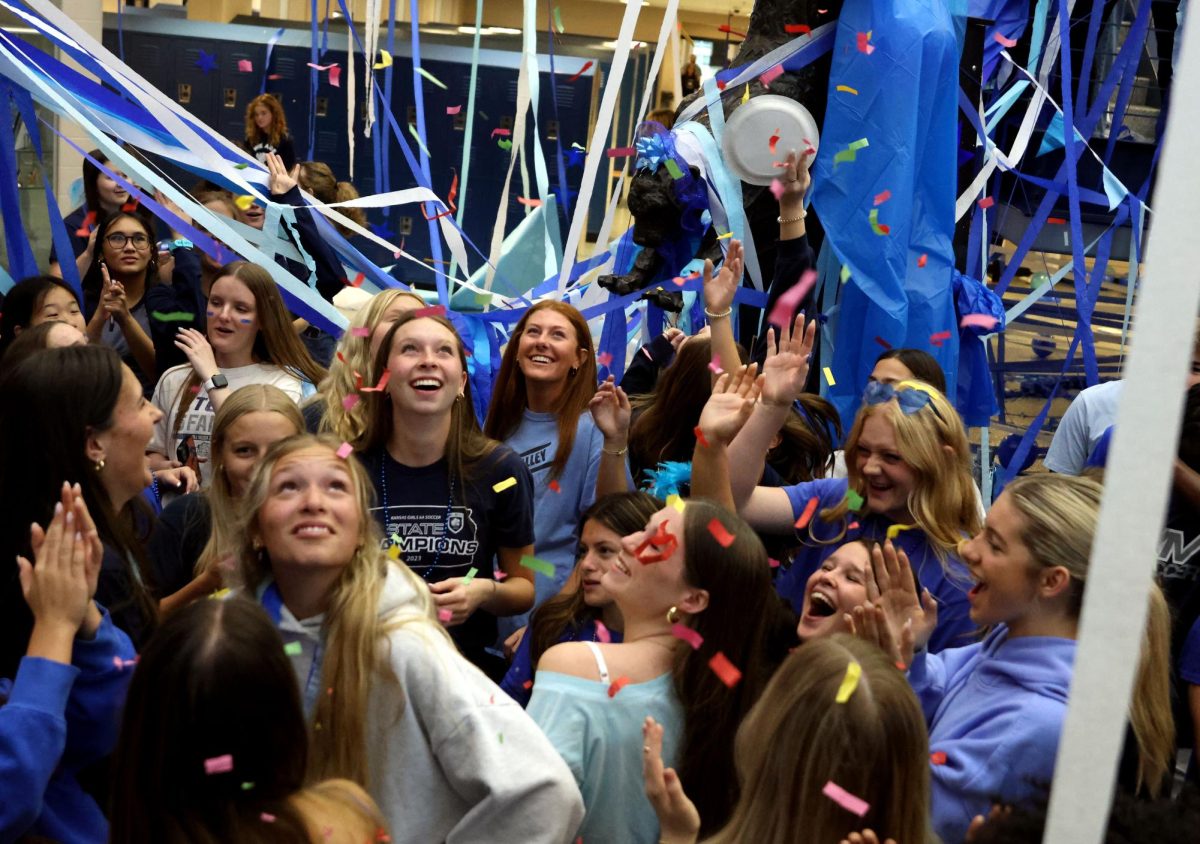 Confetti shoots into the air, as seniors watch it fall, they sing and dance.