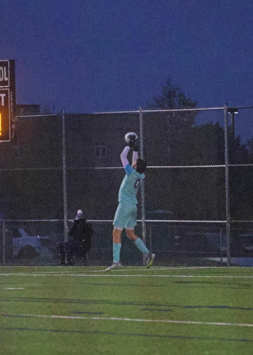 Making a save, junior Zane Hodson takes the ball out of the air.