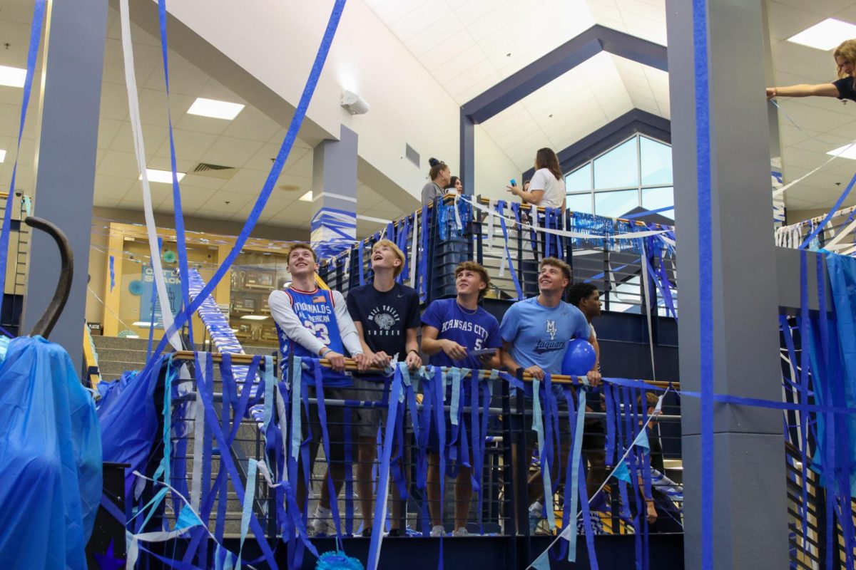 Watching streamers fall to the ground, seniors Carter Clark, Greyson Davis and Gavin Hurt stare in awe. 

