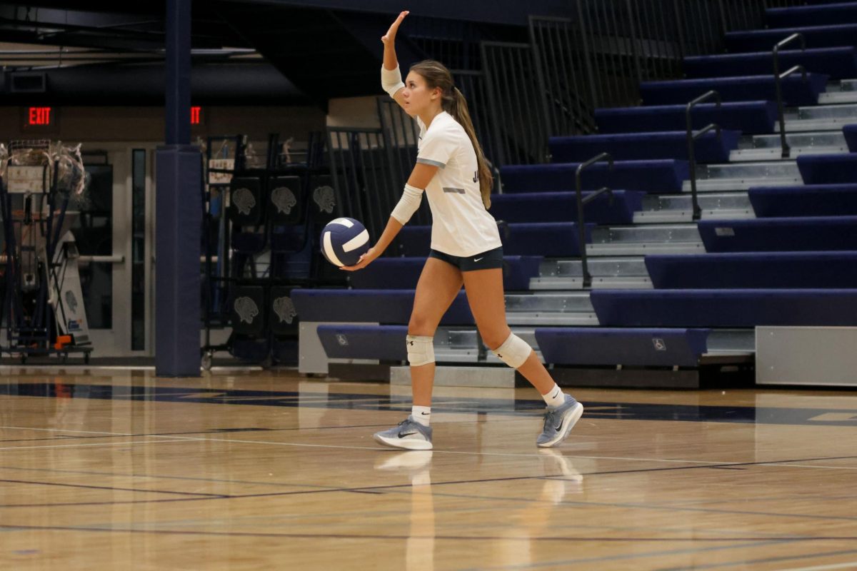 Senior Ella Flores prepares to serve the ball on Thursday Oct 2.