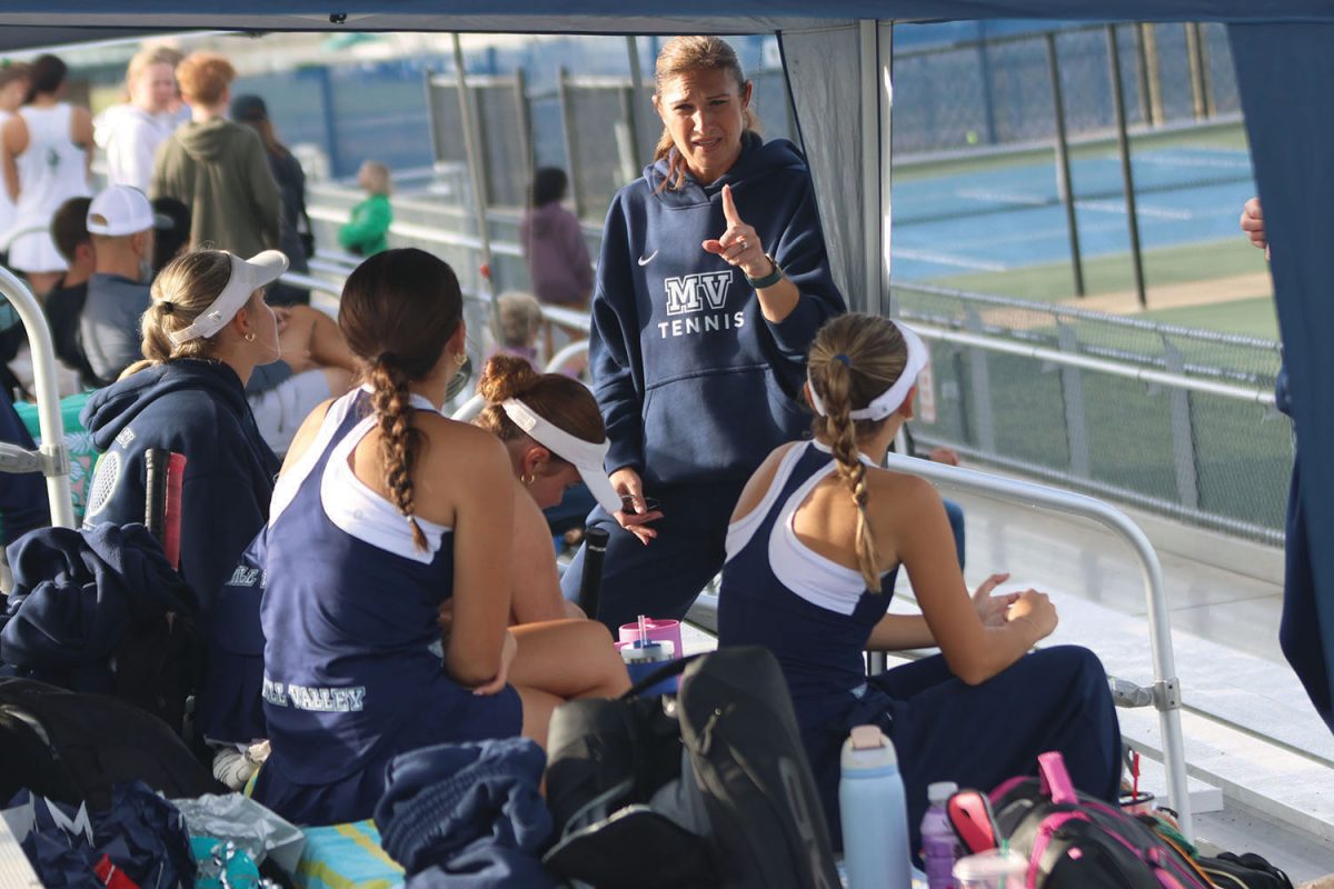Going over the schedule for the tournament, tennis coach Denise Smith tells her players what matches are up first Saturday, Oct. 11.