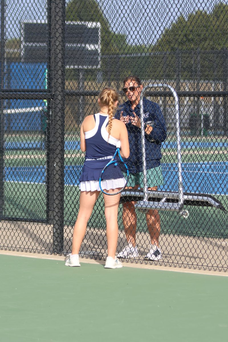 Discussing her player’s performance, tennis coach Denise Smith points out what to improve on in her next match Saturday, Oct. 11.