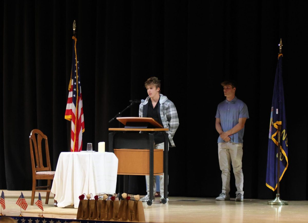 Expressing on why he plans to enlist, senior Austin Sutton speaks in front of the crowd.