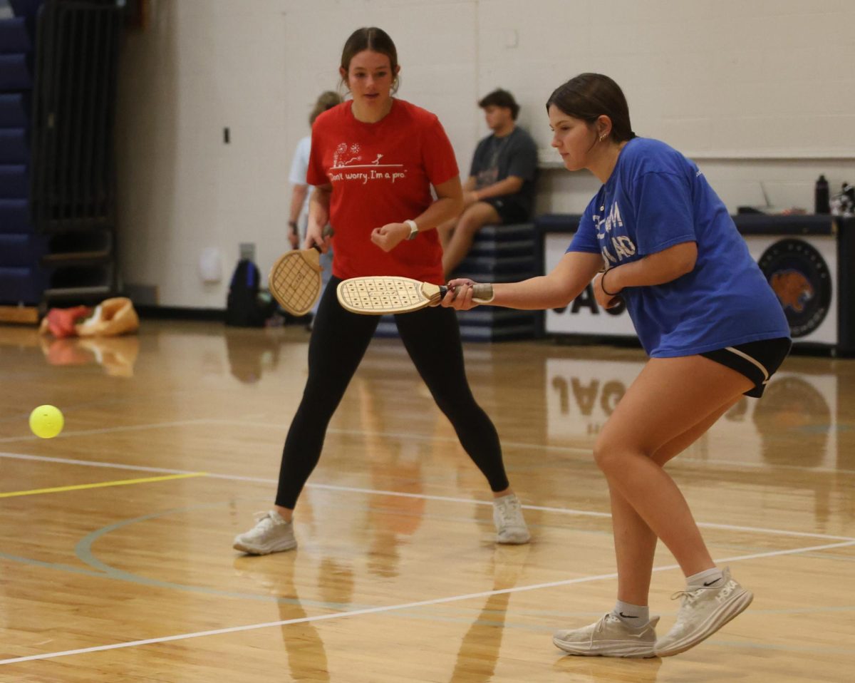 Concentrating on the ball, sophomore Nora Claycamp hits the ball over the net.