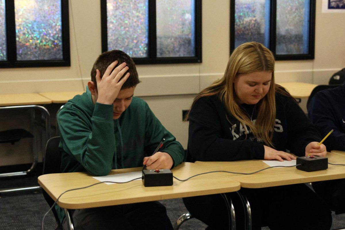 Junior Alice Hoelting and Sophomore Gavin Skahan quickly work out a math problem on their scratch paper during a 60-second math question.