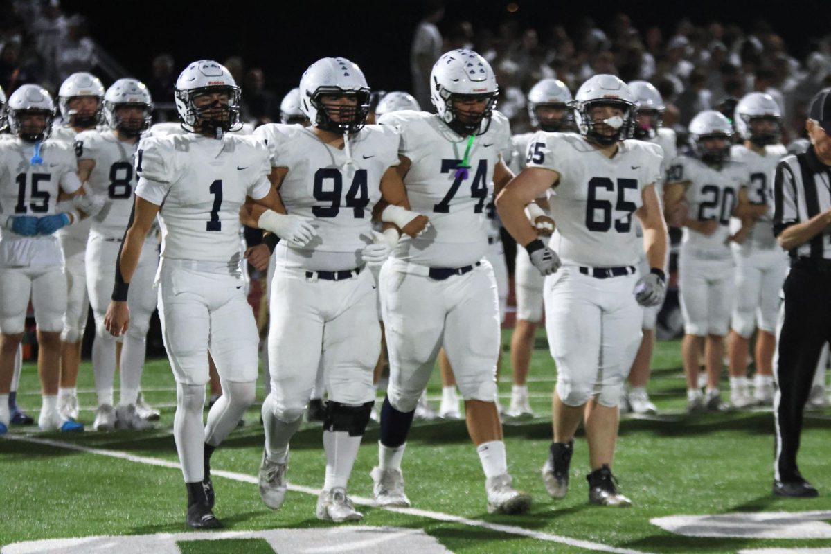 Seniors Blake Jay, Hayden Heller, Lamarcus Barber and Tommy Hopkins walk together on to the field for the coin toss.
