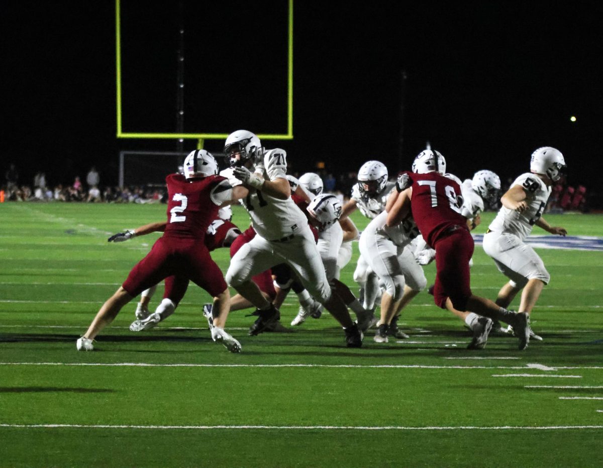 The defense attempts to tackle St. James players. 

