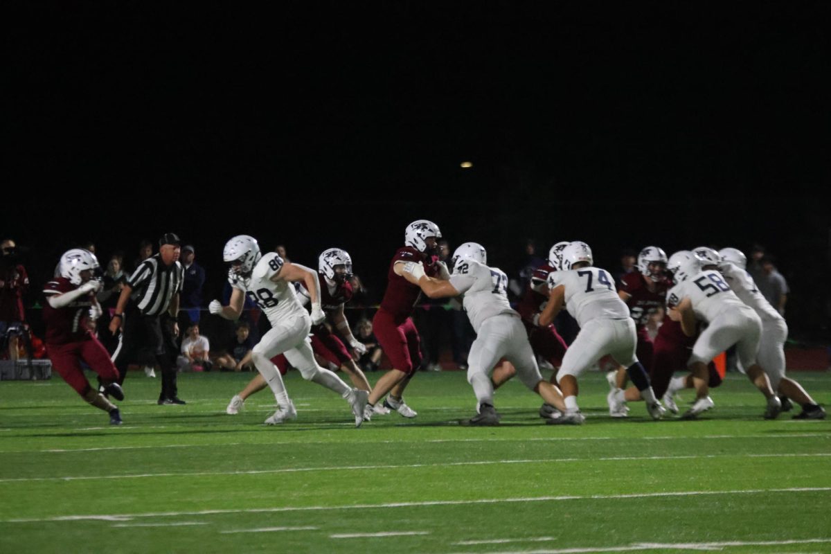 The offensive line holds back St. James’ defensive players.
