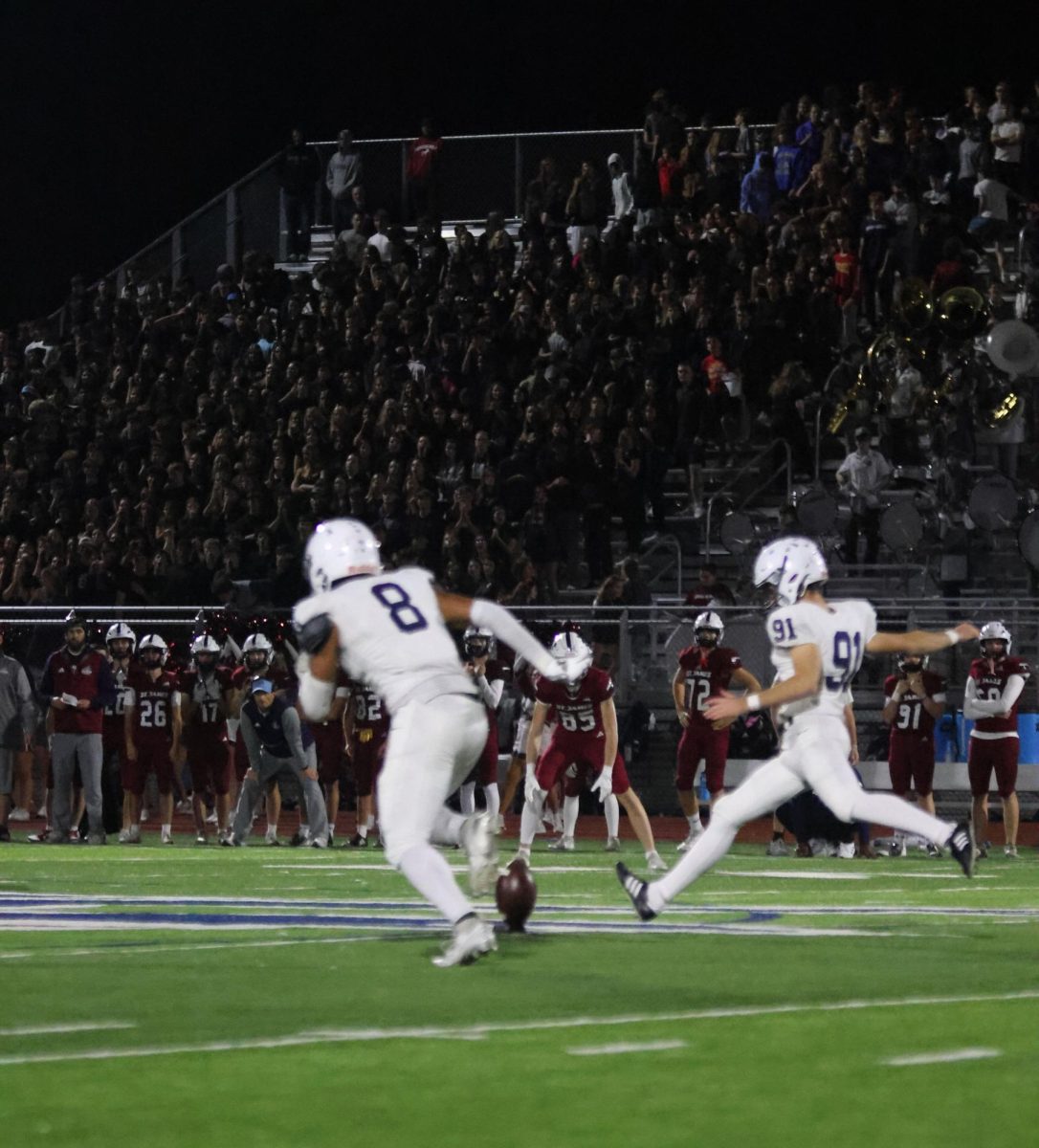 Kicker junior Mason Gallender kicks the ball down the field
