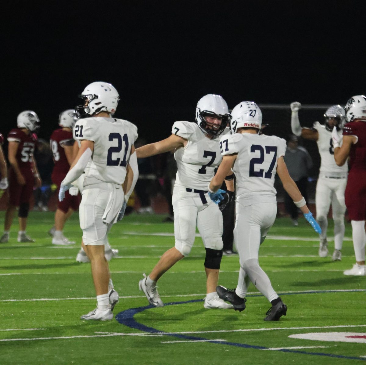 Senior Jaxon Garcia and junior Braydon Jones high five after play.
