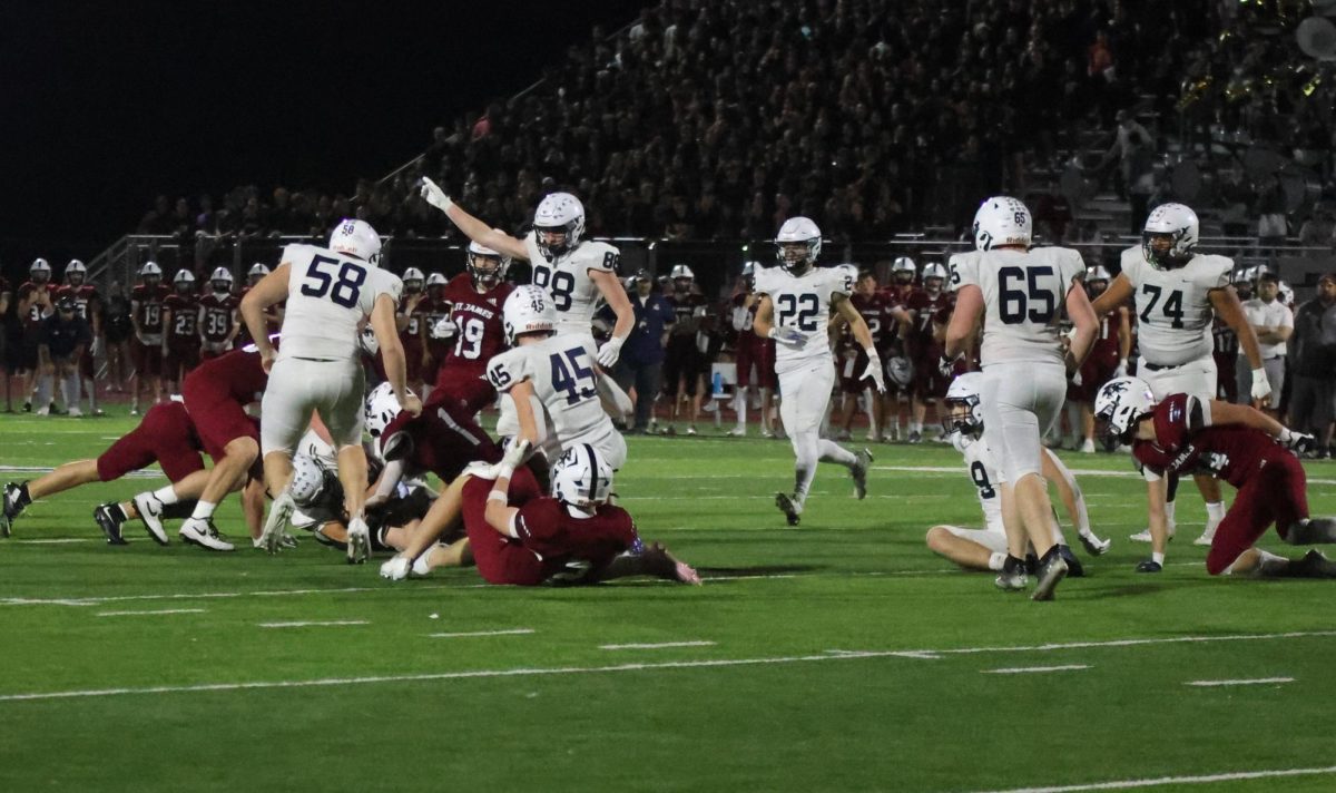 Defensive players celebrate after a tackle.
