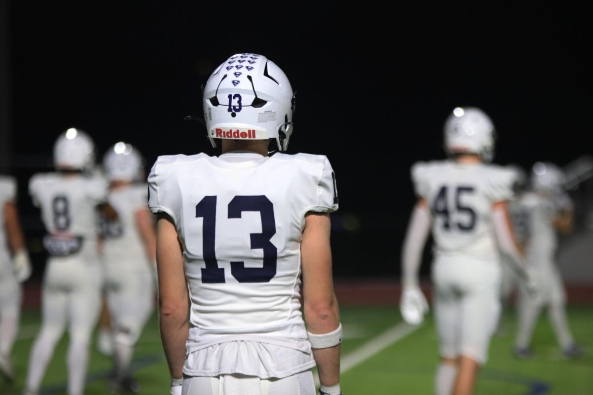 Senior Bryce Shorten stands on the sidelines after the game is over.
