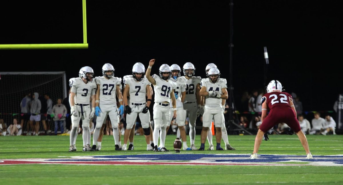 The offensive line prepares for the kick.
