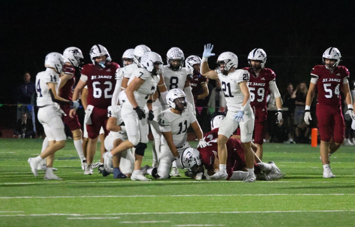 The team celebrates after a tackle. 
