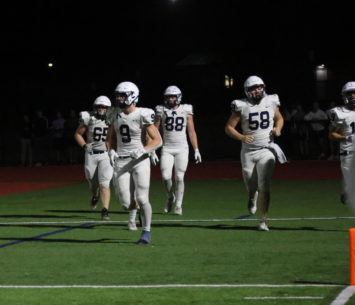 Seniors Tommy Hopkins, Michael Fitzpatrick and juniors Max Piva and Stone Zambo run back to the field after a touchdown.
