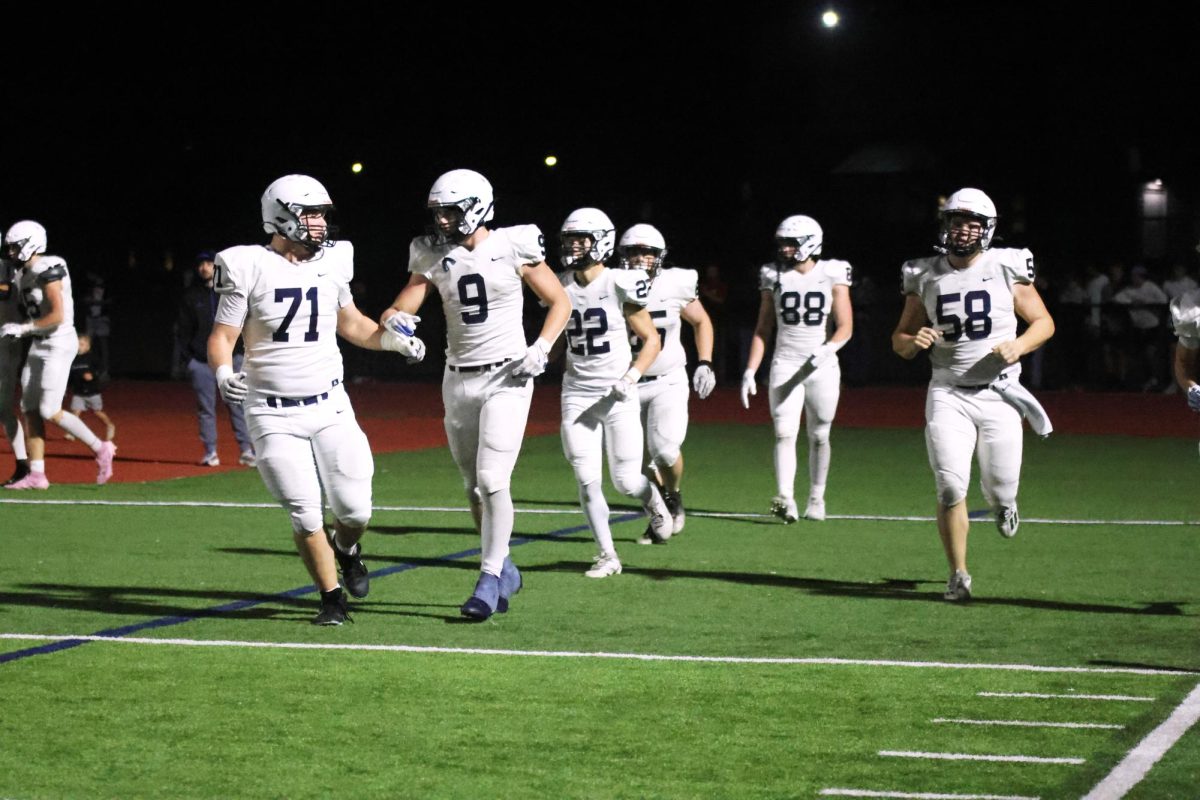 Senior Zach Darr and junior Max Piva fist bump after touchdown. 

