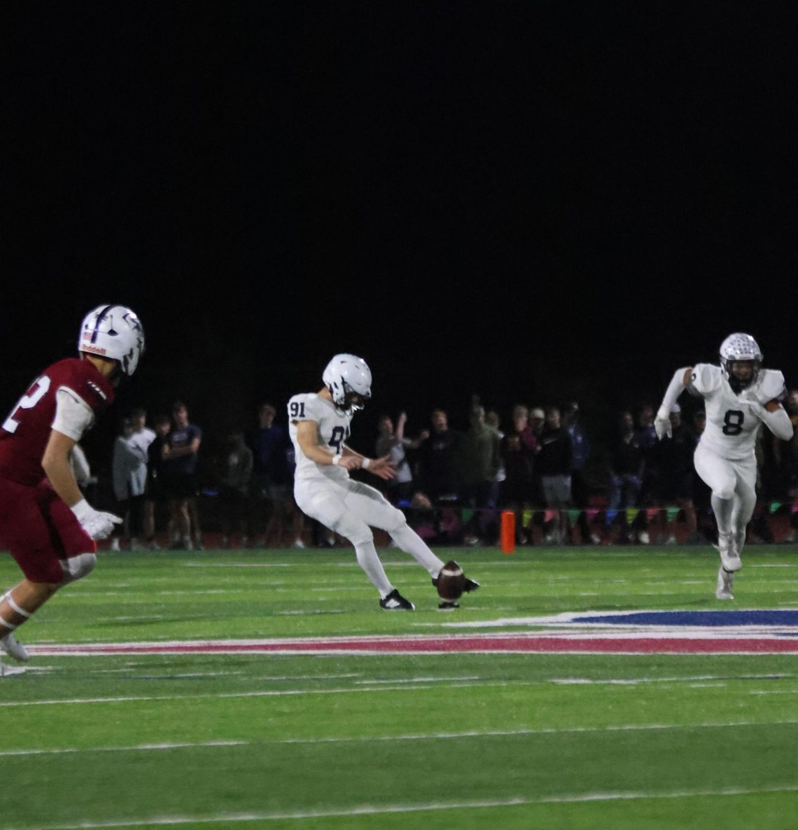 Kicker junior Mason Gallender kicks the ball down the field
