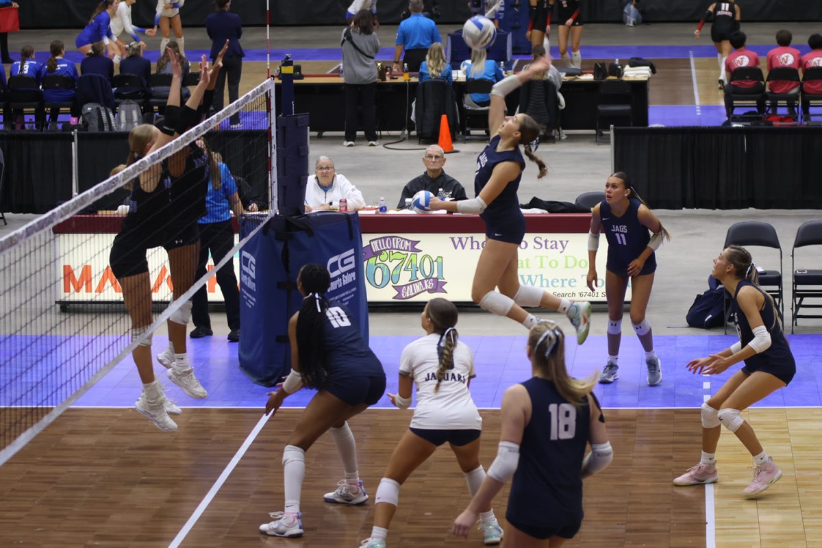Sophomore Ellie Bain attempts the kill in set one versus Olathe Northwest.