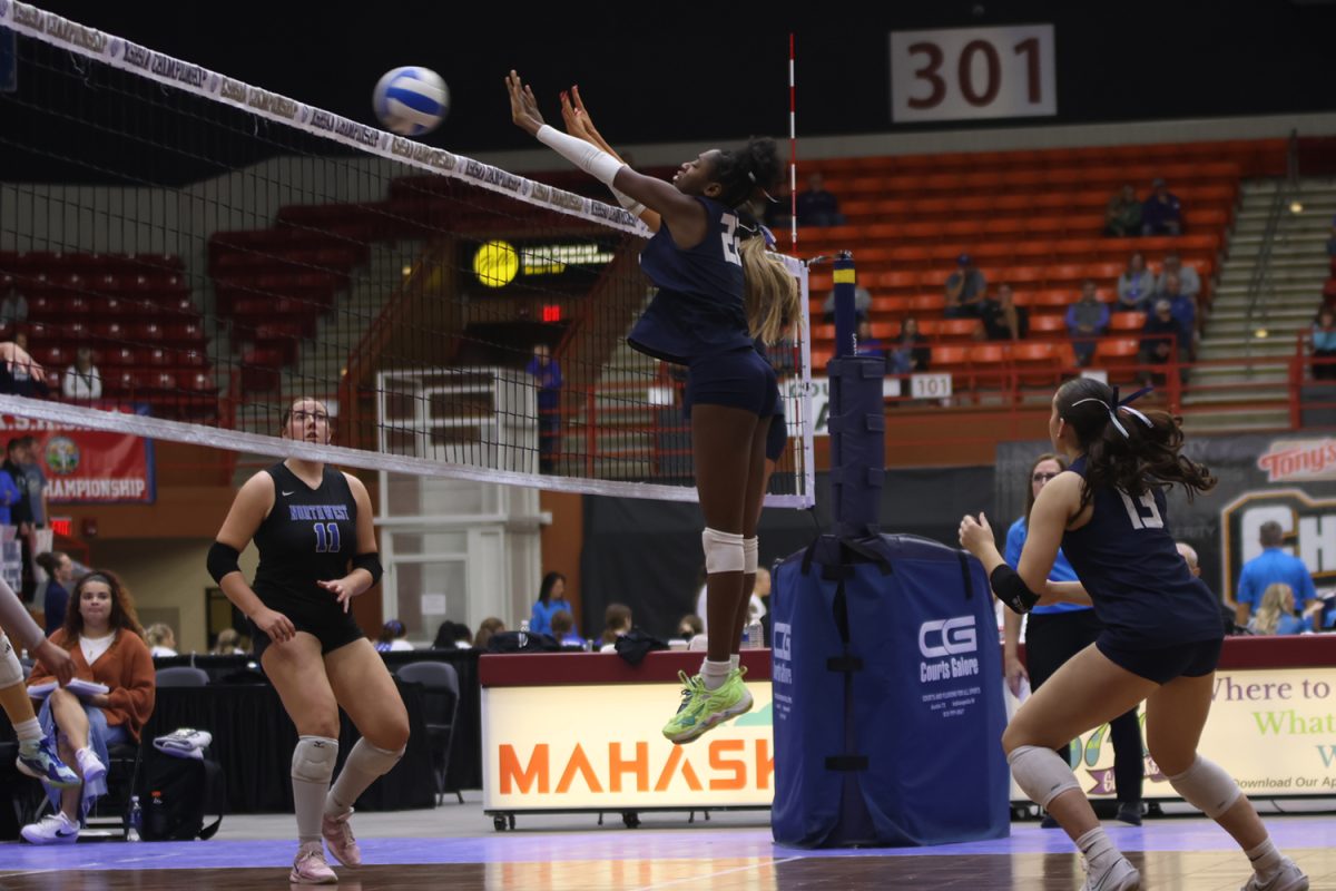 Seniors Olivia Nzioki and Ella Florez attempt a block on the Olathe Northwest middle hitter.