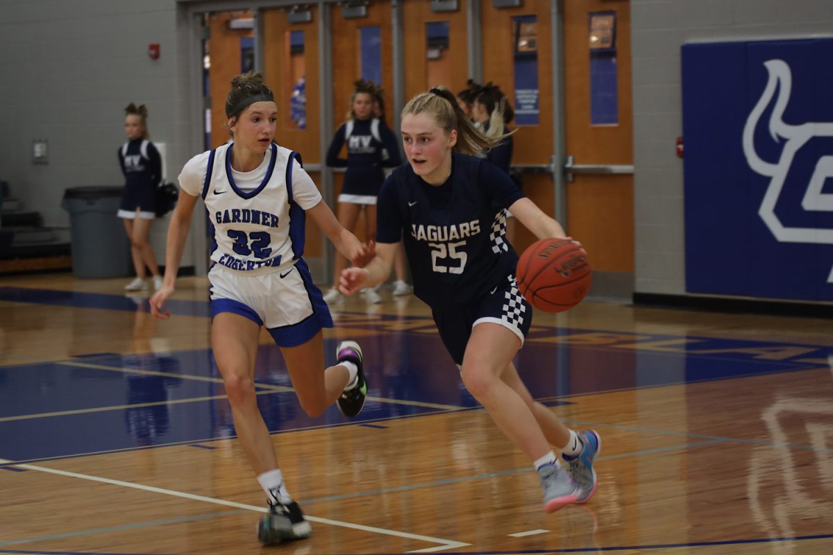 Looking to pass the ball to her teammate, freshman Riley Marshall attempts to rush past her opponent, Dec. 8, 2023.