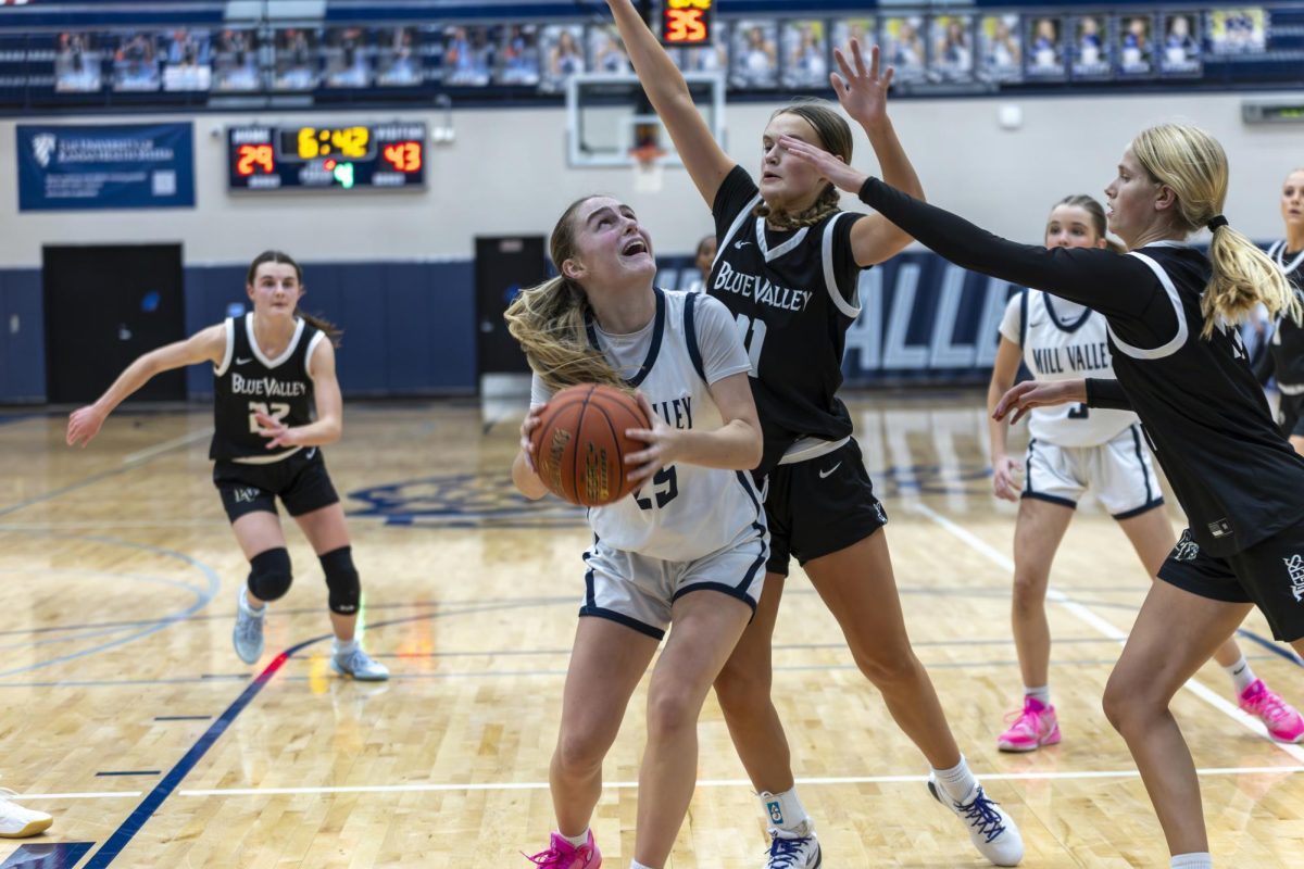 Junior Riley Marshal prepares to shoot while her defender reaches over her