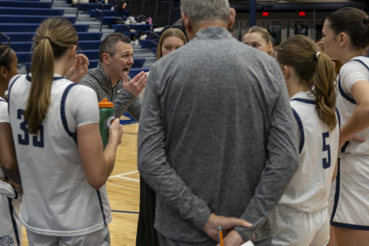 Head coach Adam Runyan yells at the team the plan for the next play to hopefully pull the team ahead. 