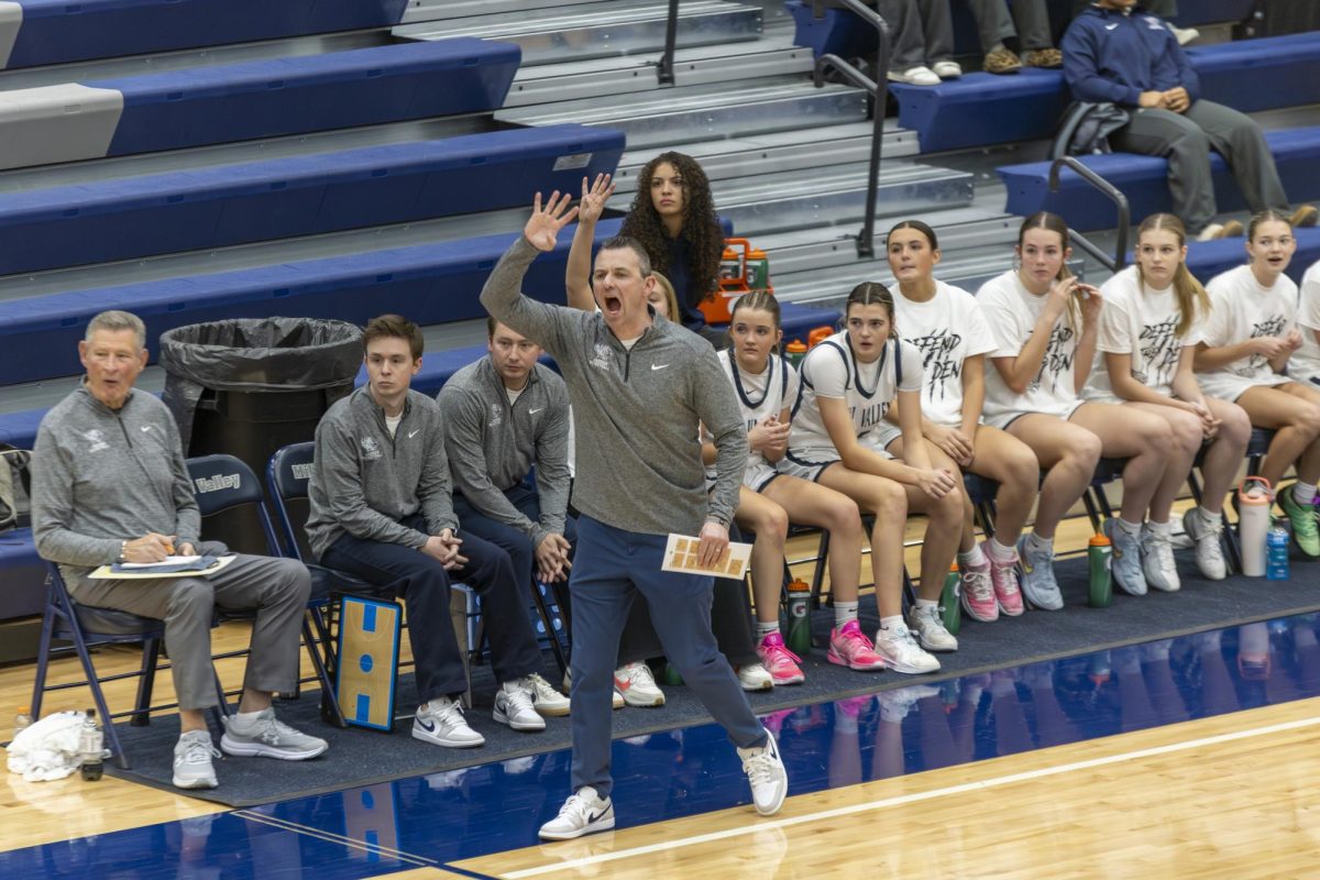 Head coach Adam Runyan screams the time left on the shot clock at a player waiting to take a shot. 