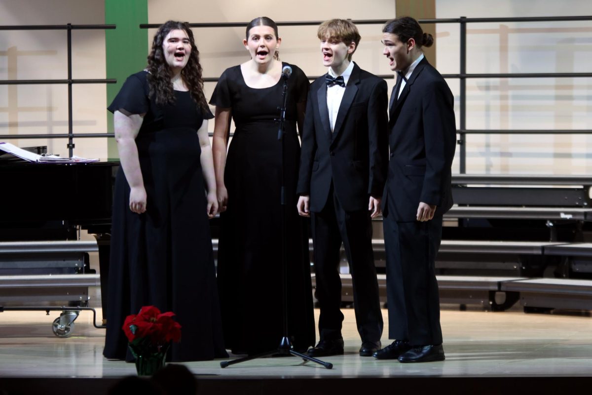 Working together seniors Keegan Wotton, Harrison Guest, Samantha McCoy, and Josey Crossley give their rendition of "Jingle Bell Rock."