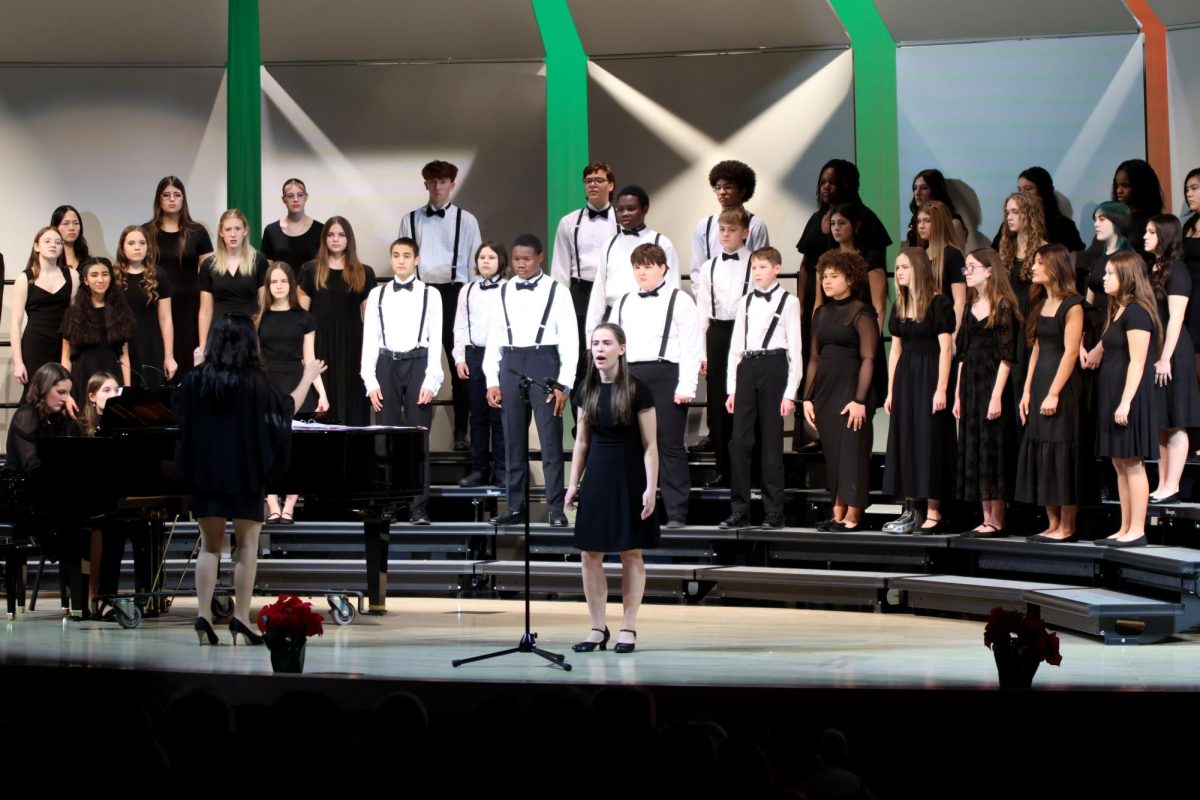 Accompanied by the choir Maylee Mixon closes out the song "Once Upon A December."