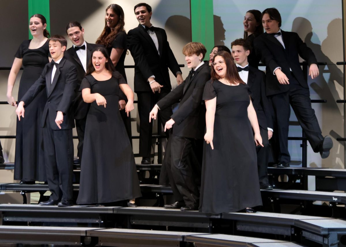 Senior Harrison Guest, juniors Lucy Suman, Will Ottesen and Lacey Jennings sing together. 