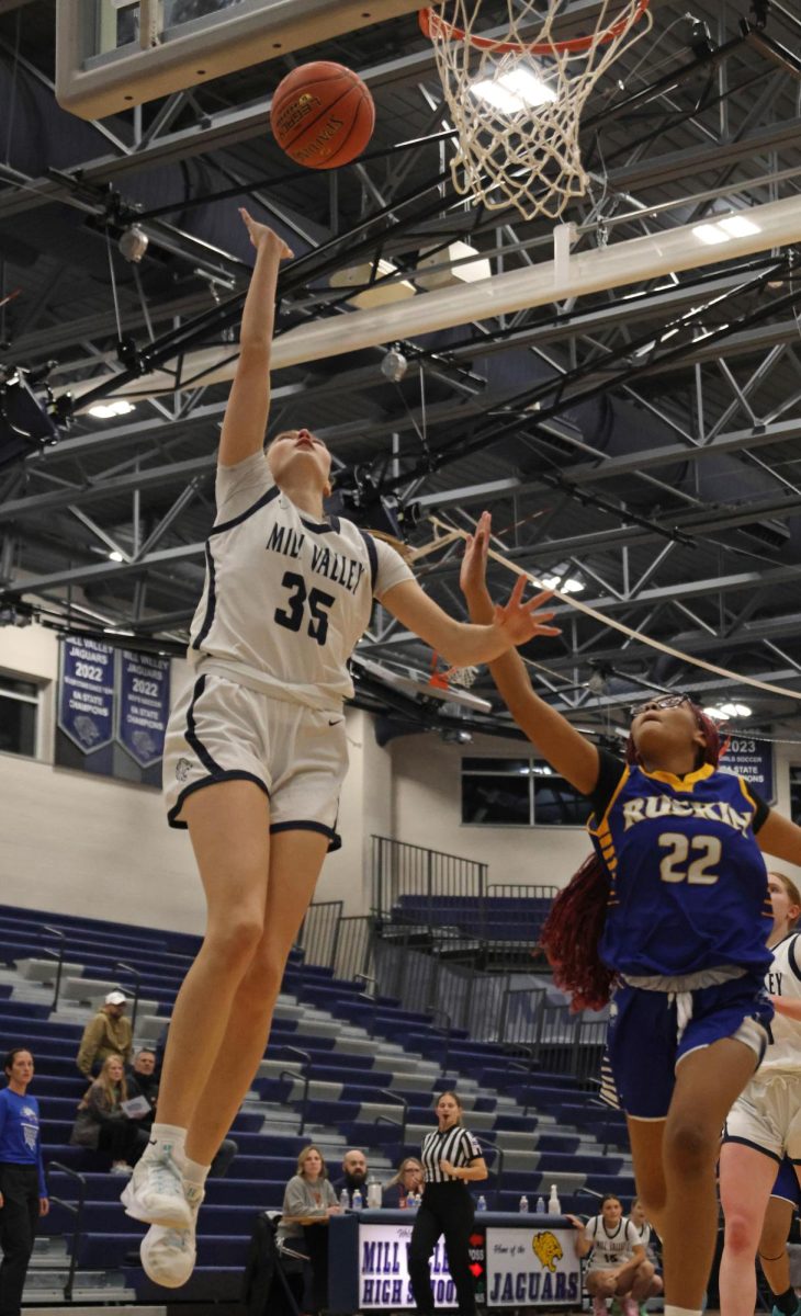 Going up for a layup, junior Faith Pittenger scores a basket.