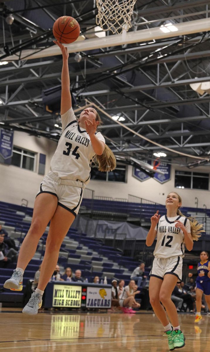 Going to the basket, sophomore Emily Izatt makes a layup.
