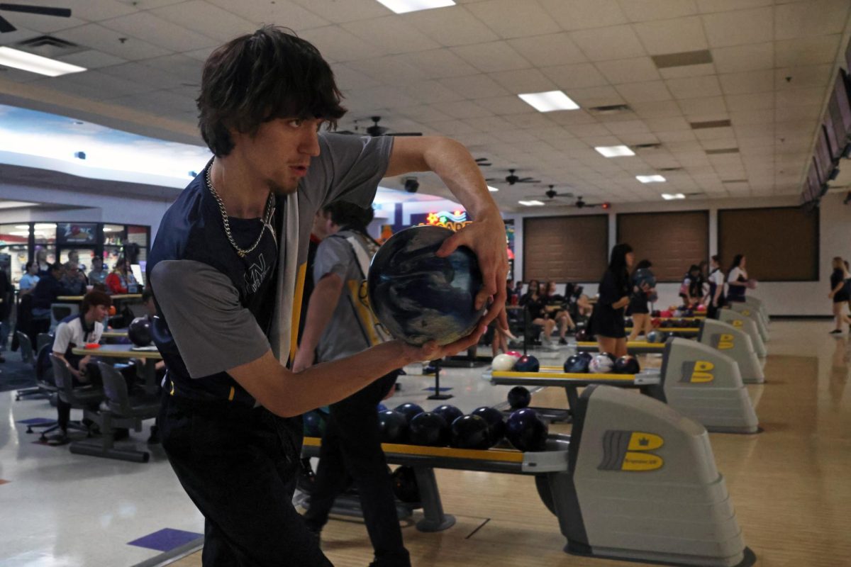 Using the two hand bowling method, junior Jake Brown focuses onto the pins for a strike, Jan. 23, 2025