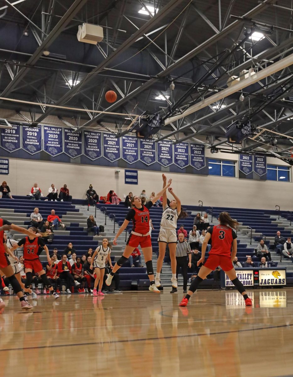 From the paint, senior Paige Roth shoots against the defense.