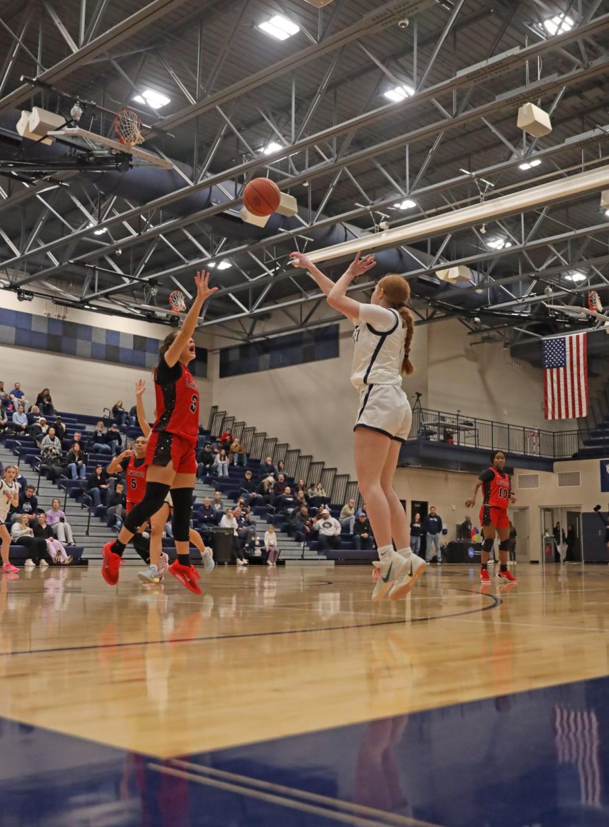 Scoring, senior Leah Konen, makes a three.