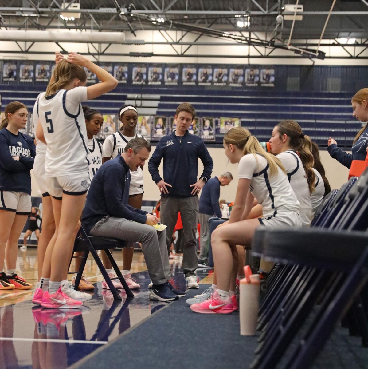 During a timeout, Coach Adam Runyan draws up a play for the Jags.