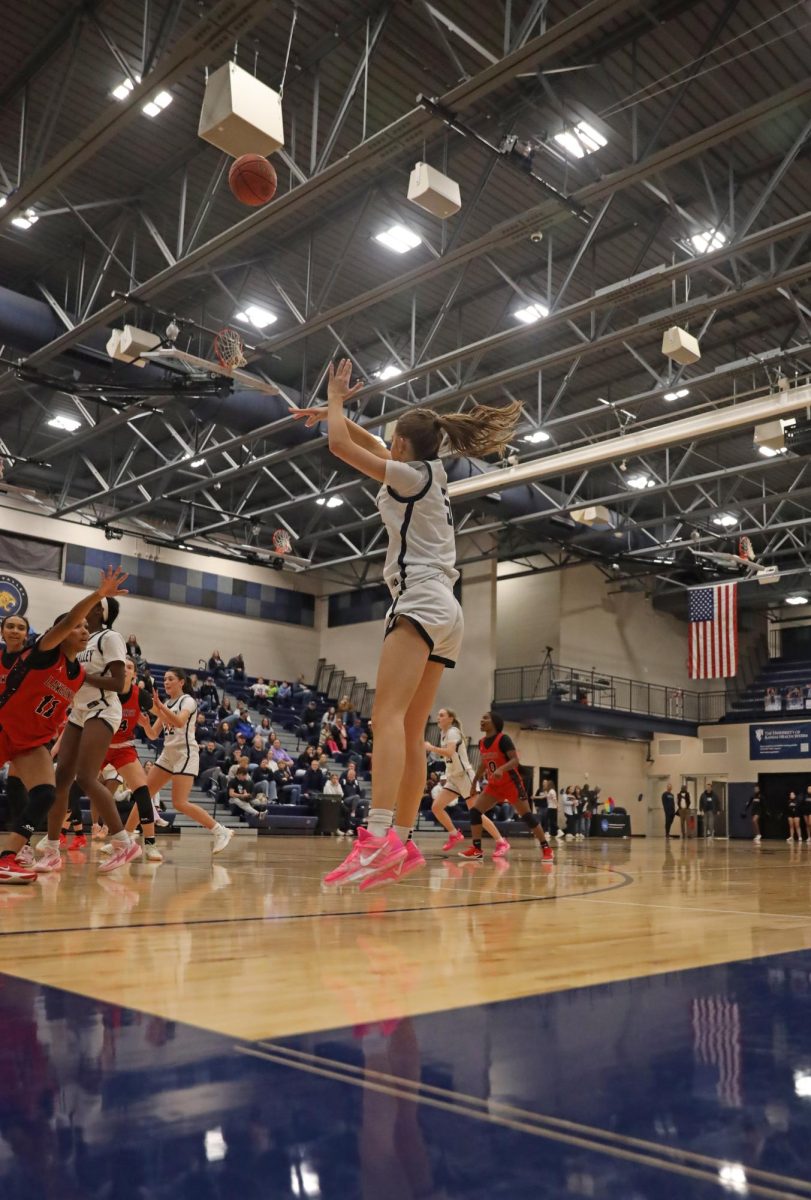 In the corner, sophomore Elin Diskin makes the three.