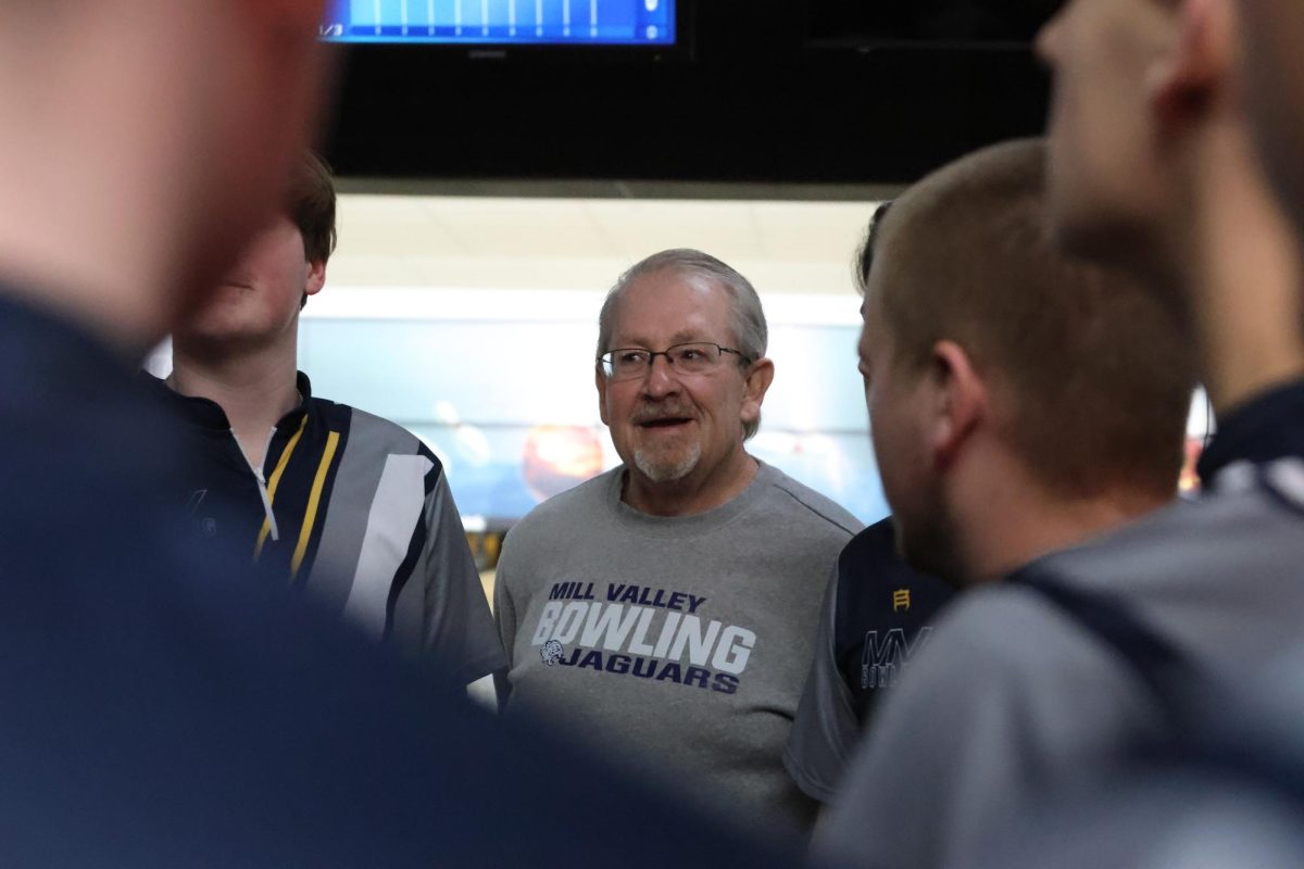 bowling coach Brian McDaneld prepares the team before the start of the meet. 