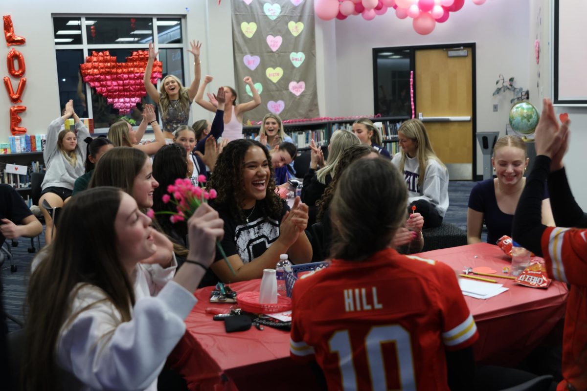 Cheering with pride, the teams celebrate after answering a question correctly.  