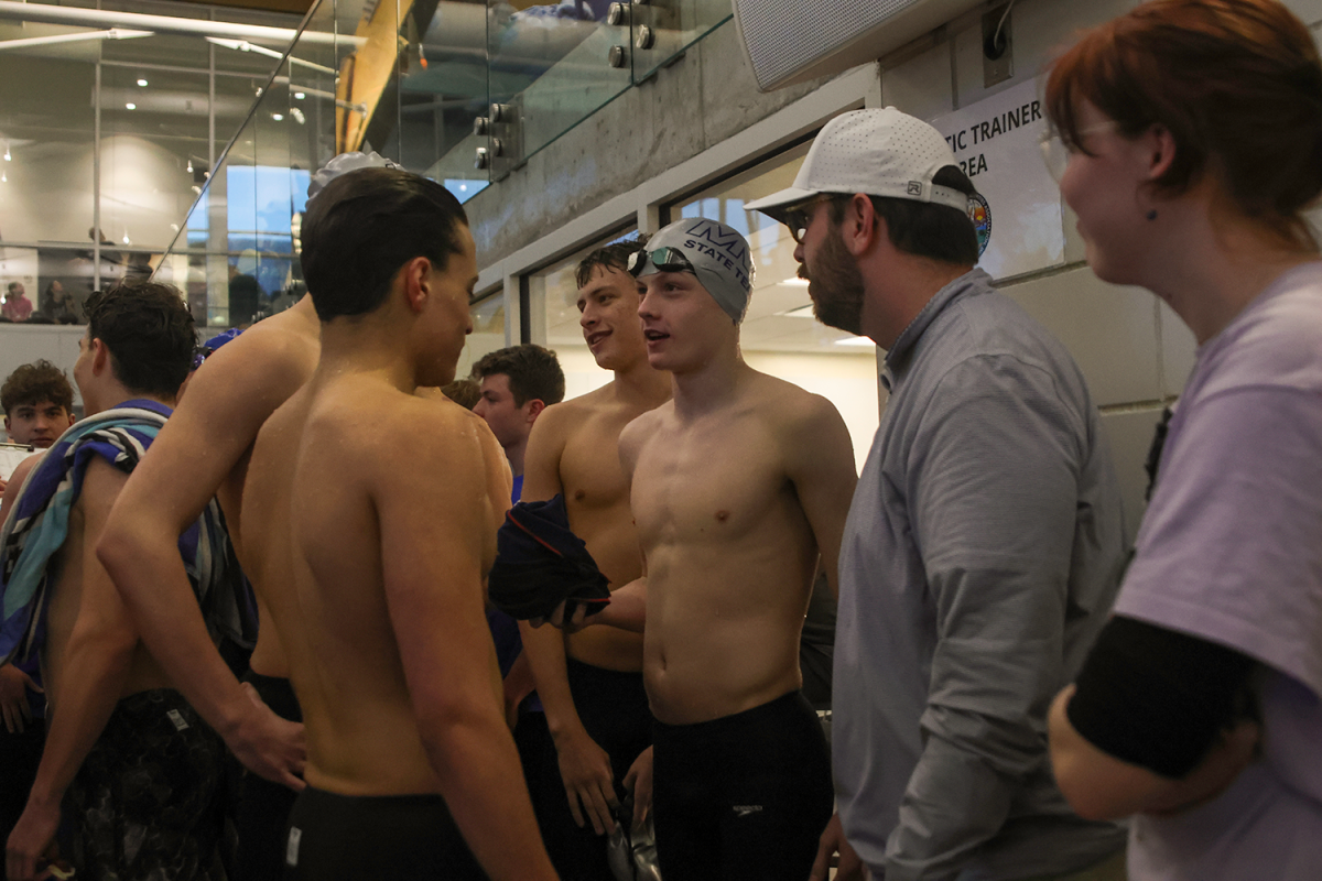 After a good race the team talks at the side of the pool